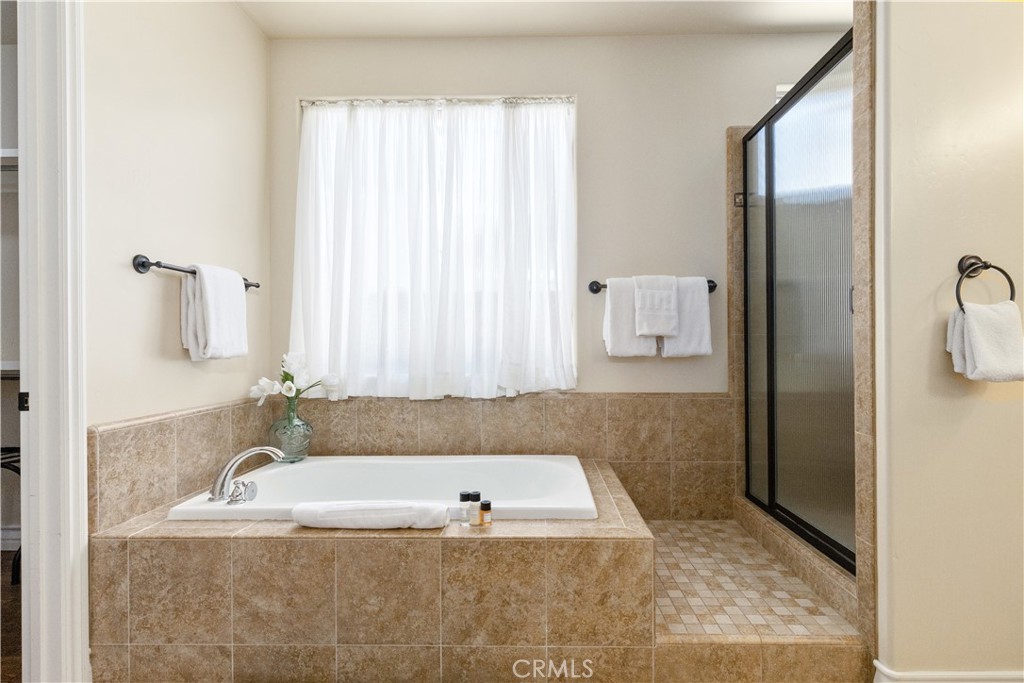669 Red Cloud Road Paso Robles, CA 93446 - Photo 24 of 61 a bath tub sitting in a bathroom next to a window