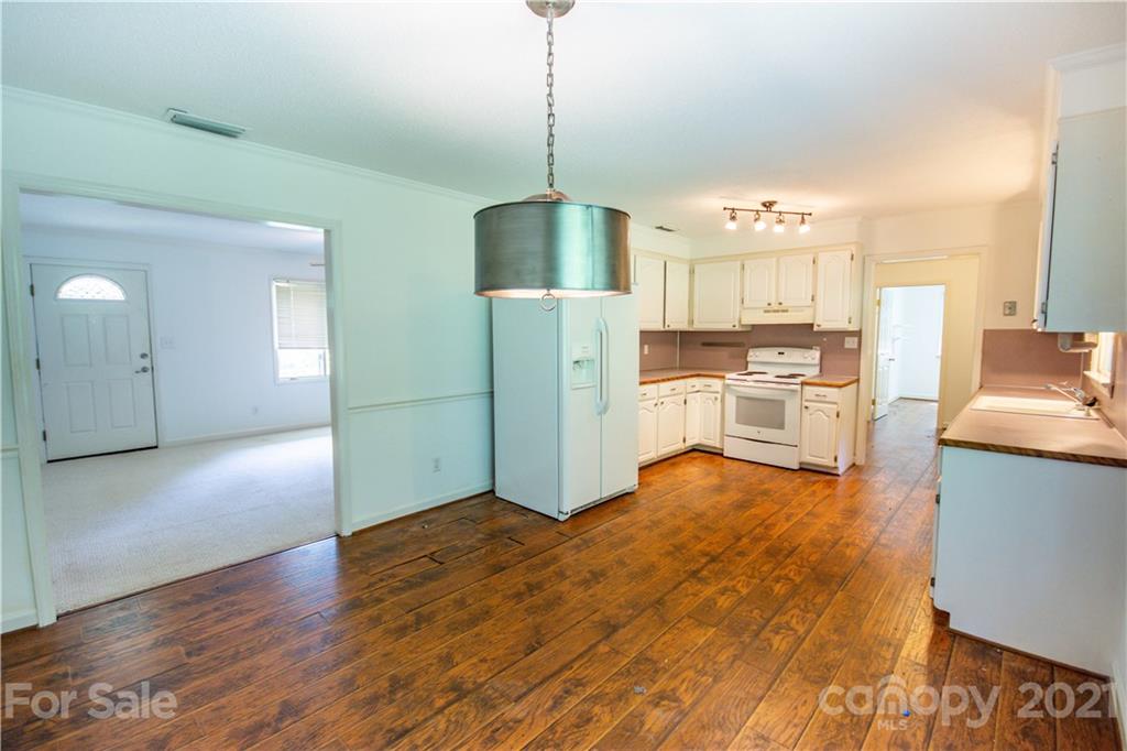 144 Buffaloway Road Statesville, NC 28677 - Photo 11 of 33 a kitchen with stainless steel appliances granite countertop a refrigerator a stove top oven a sink dishwasher and a refrigerator with wooden floor