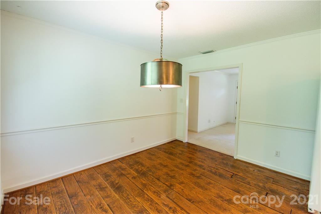 144 Buffaloway Road Statesville, NC 28677 - Photo 12 of 33 a view of empty room with wooden floor and fan