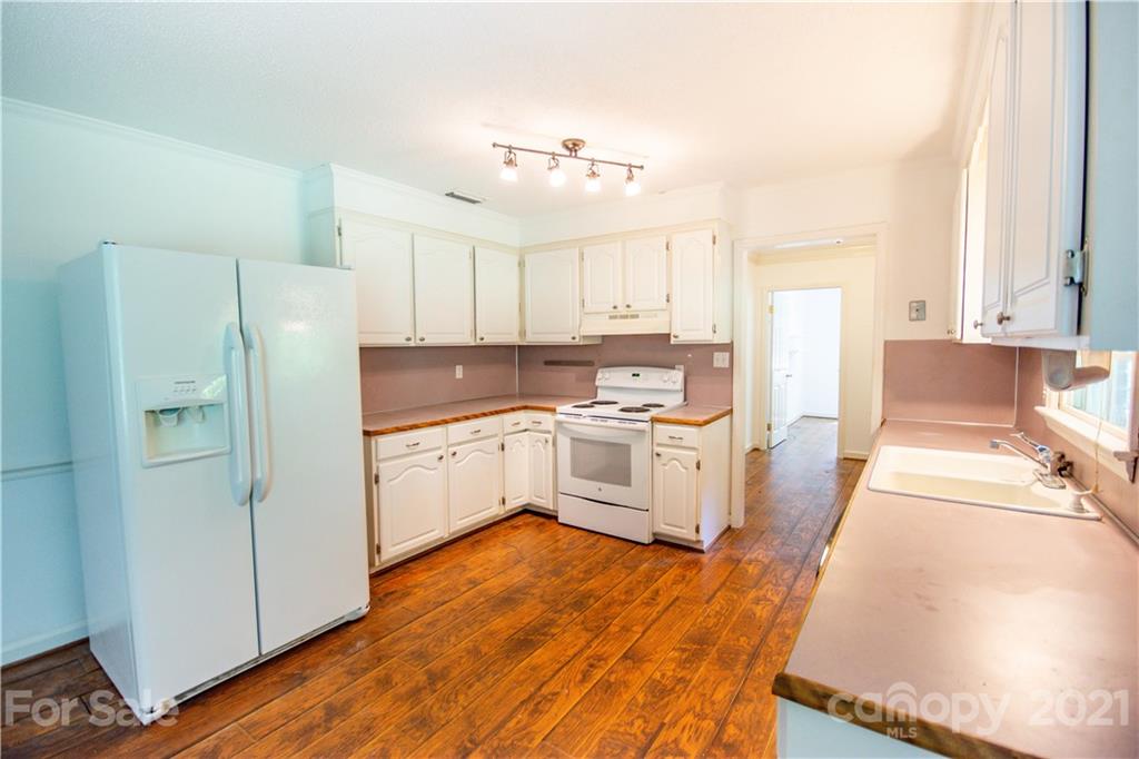 144 Buffaloway Road Statesville, NC 28677 - Photo 14 of 33 a kitchen with white cabinets and white appliances