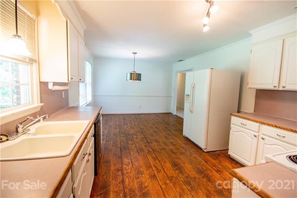 144 Buffaloway Road Statesville, NC 28677 - Photo 16 of 33 a kitchen with a refrigerator a sink and a stove top oven