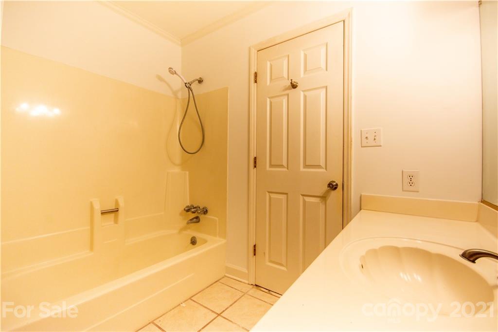 144 Buffaloway Road Statesville, NC 28677 - Photo 21 of 33 a bathroom with a tub shower vanity and a sink