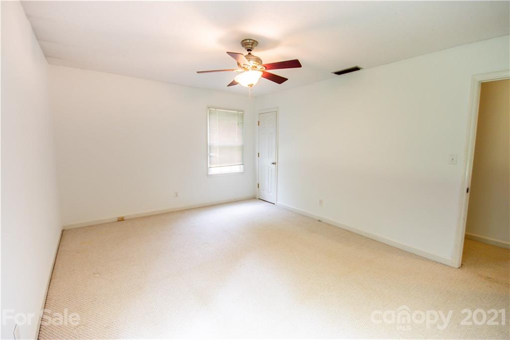 144 Buffaloway Road Statesville, NC 28677 - Photo 30 of 33 an empty room with a window and a ceiling fan