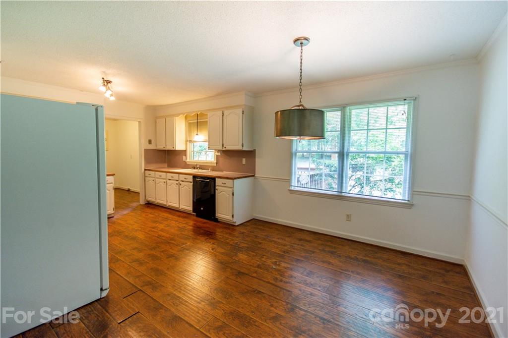144 Buffaloway Road Statesville, NC 28677 - Photo 10 of 33 a kitchen with stainless steel appliances granite countertop a refrigerator a sink dishwasher a stove and white countertops with wooden floor