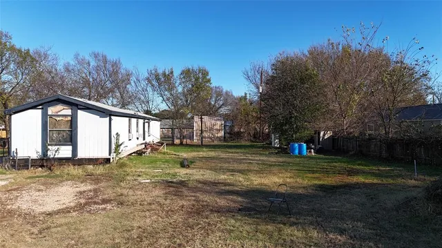 a view of a yard with a house in the background