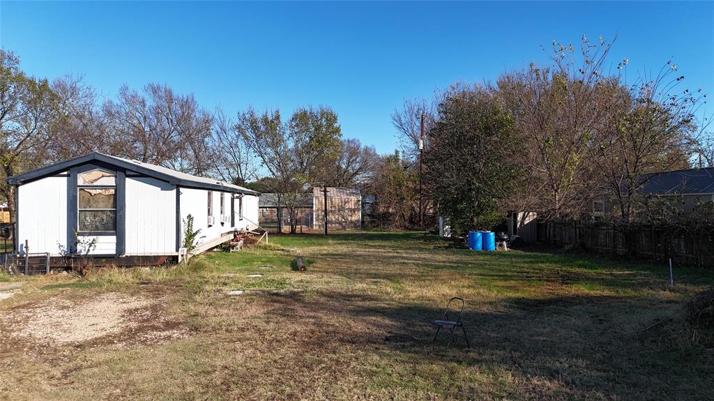 214 Pearson Lane Azle, TX 76020 - Photo 2 of 8 a view of a yard with a house in the background