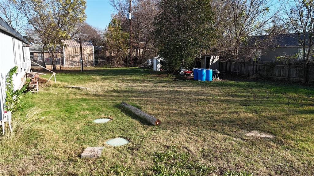 214 Pearson Lane Azle, TX 76020 - Photo 7 of 8 a backyard of a house with fountain basket ball court and outdoor seating