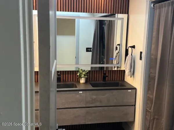 a bedroom with a large bed and a large window