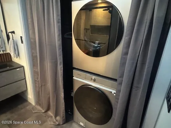 a bathroom with a granite countertop sink and a toilet