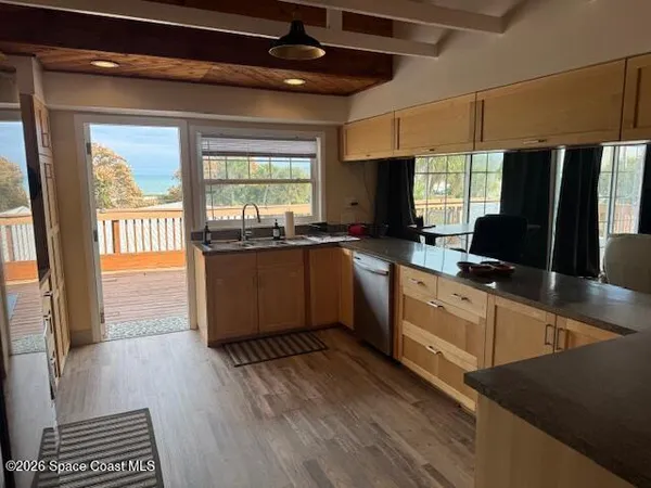 a kitchen with kitchen island a large counter top space appliances and windows