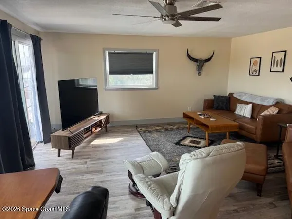 a dining room with furniture and wooden floor