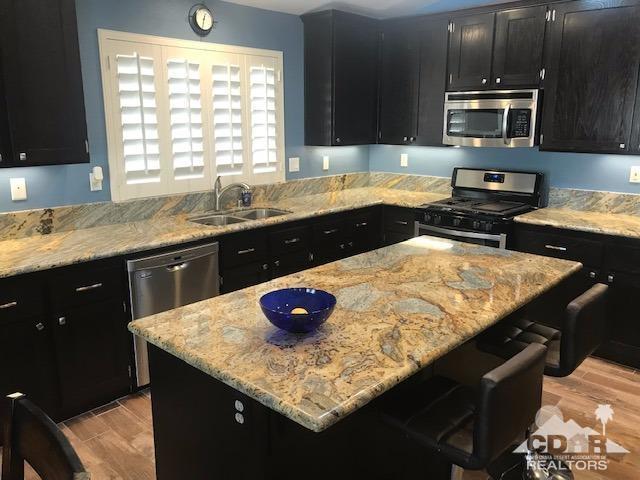 78658 Ewarton Road Bermuda Dunes, CA 92203 - Photo 1 of 10 a kitchen with a sink a stove and wooden floor