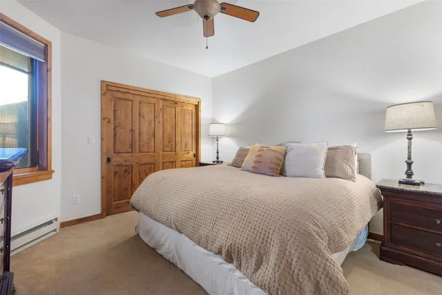 a bedroom with a bed and a lamp