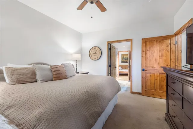 a bedroom with a large bed and a chandelier