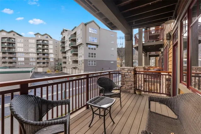 a view of balcony with a potted plant and wooden floor