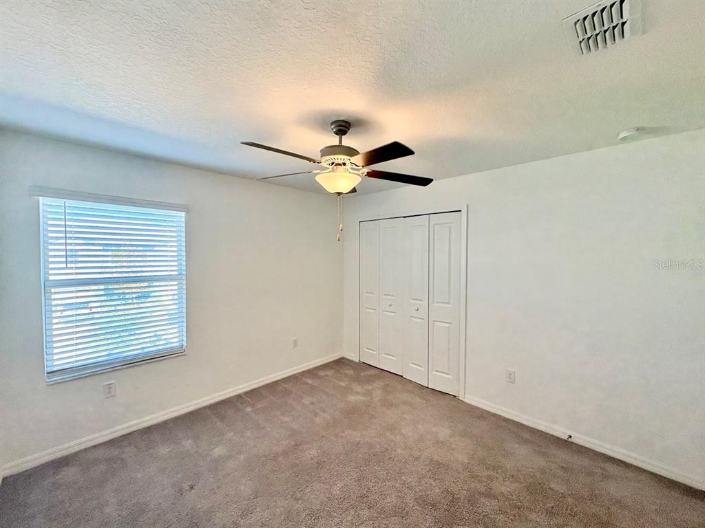 14302 Editors Note Street Ruskin, FL 33573 - Photo 20 of 28 a view of an empty room with a ceiling fan