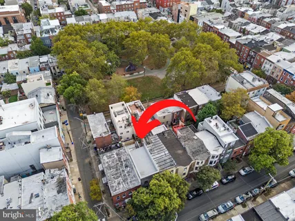 an aerial view of a houses with yard