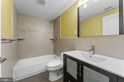a bathroom with a sink a toilet and bathtub