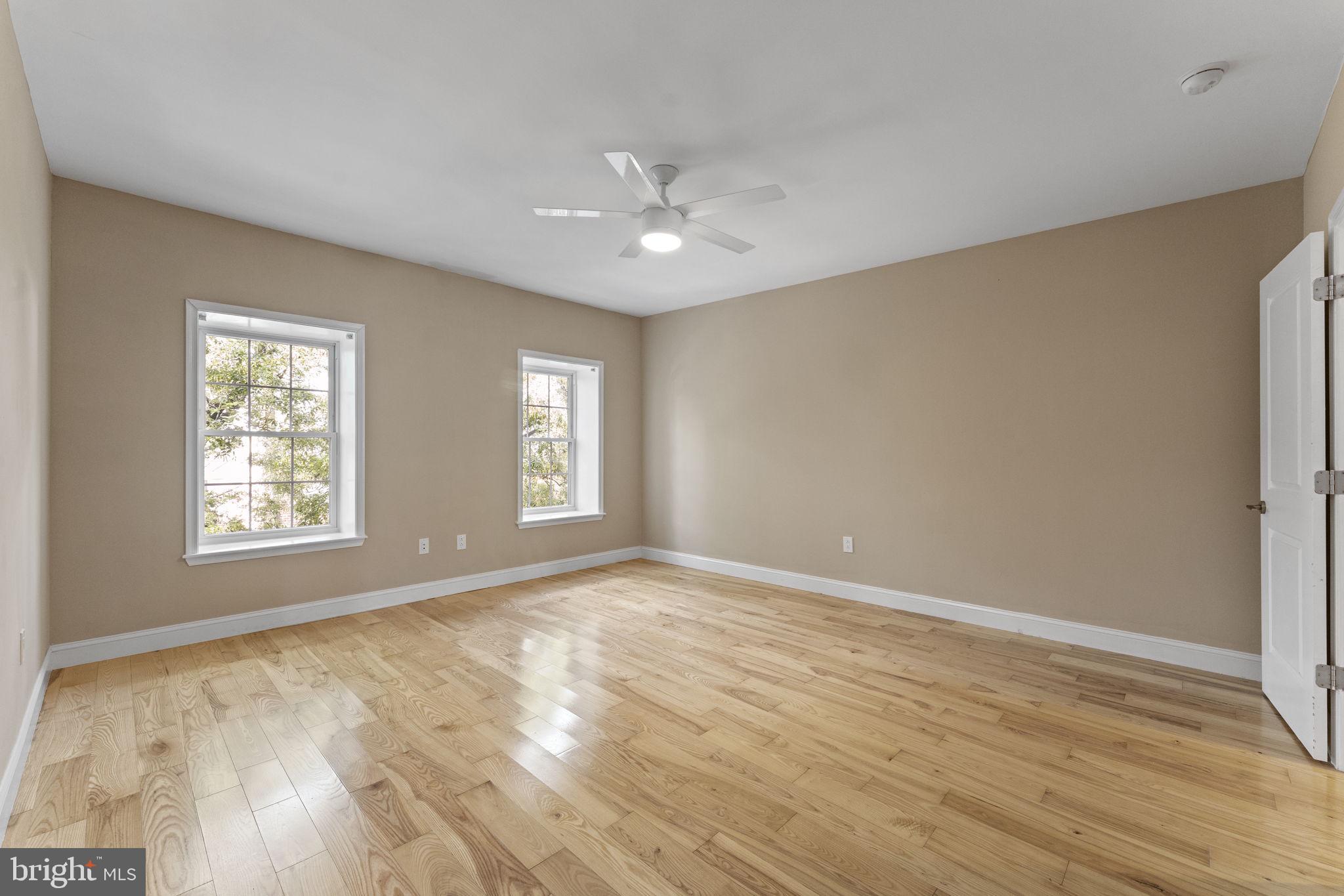 1225 South 7th Street Philadelphia, PA 19147 - Photo 16 of 33 a view of an empty room with wooden floor and a window