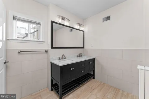 a bathroom with a sink mirror and vanity