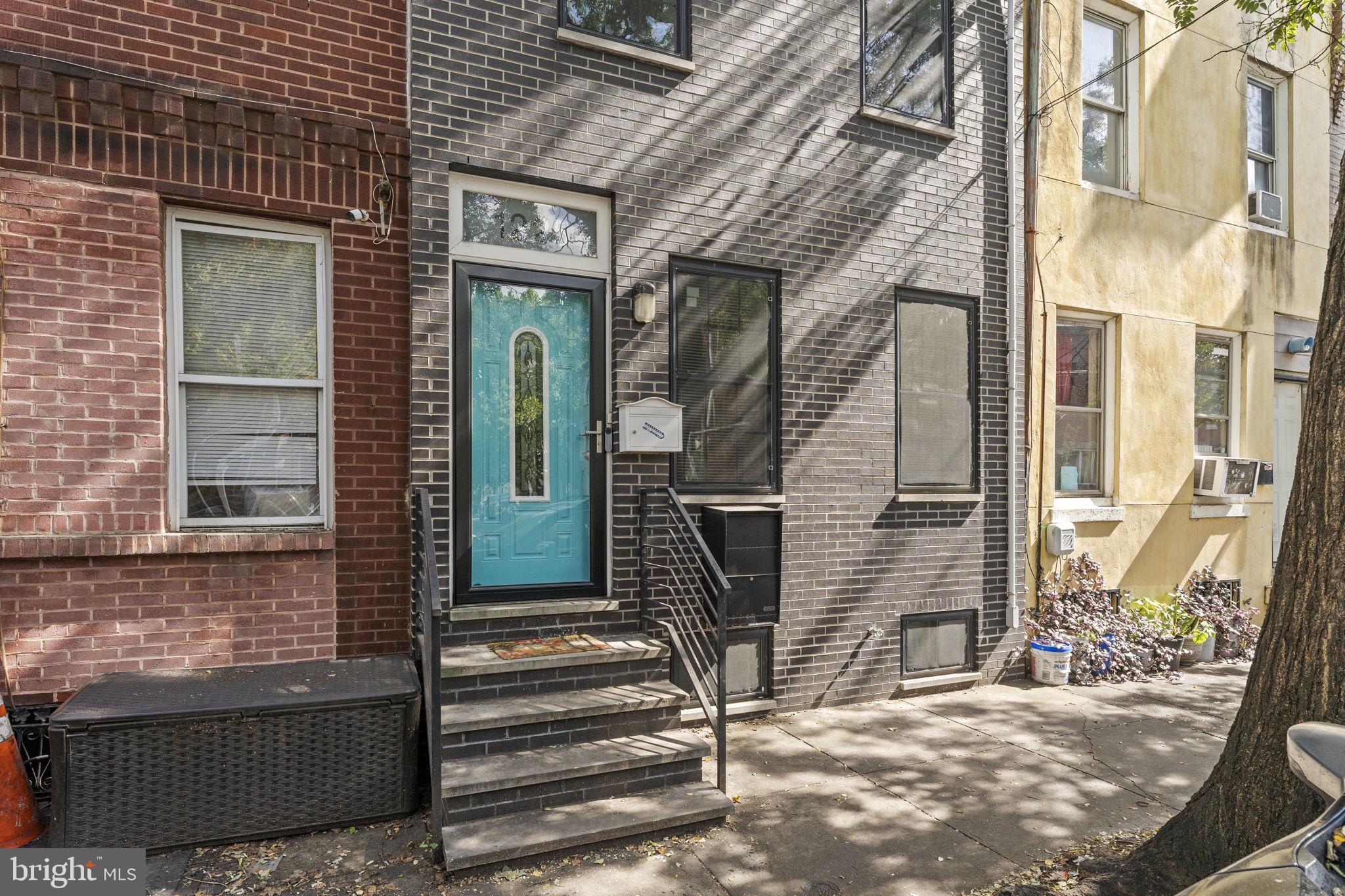 1225 South 7th Street Philadelphia, PA 19147 - Photo 2 of 33 a view of a brick house with a door and a window