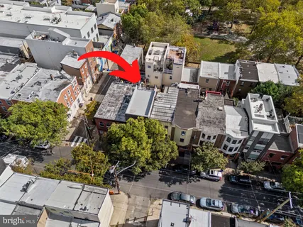 an aerial view of a house with a yard and lake view