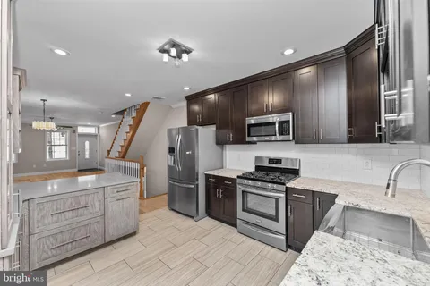 a kitchen with a sink stainless steel appliances and cabinets