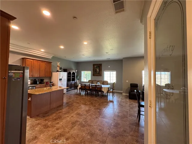 a kitchen with sink refrigerator and furniture
