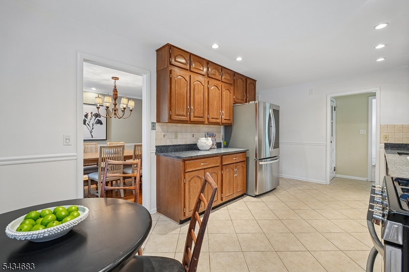 106 Division Avenue Summit, NJ 07901 - Photo 13 of 38 a kitchen with stainless steel appliances a refrigerator and a stove