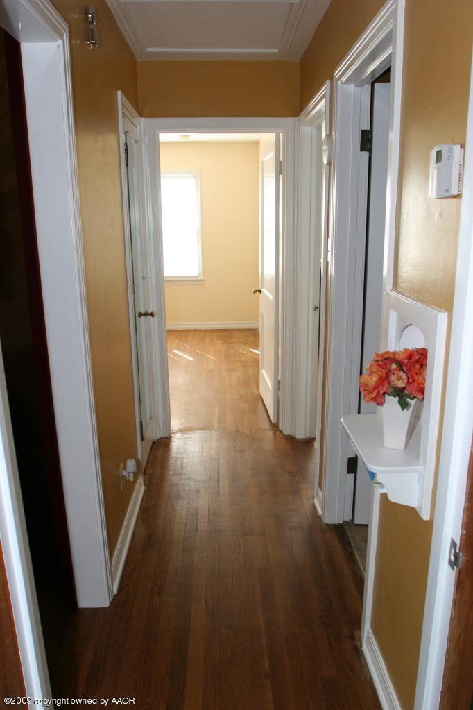 3622 South Travis Street Amarillo, TX 79110 - Photo 13 of 32 a view of hallway with furniture and wooden floor