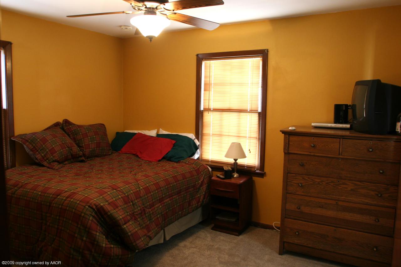3622 South Travis Street Amarillo, TX 79110 - Photo 15 of 32 a bedroom with a bed and a window