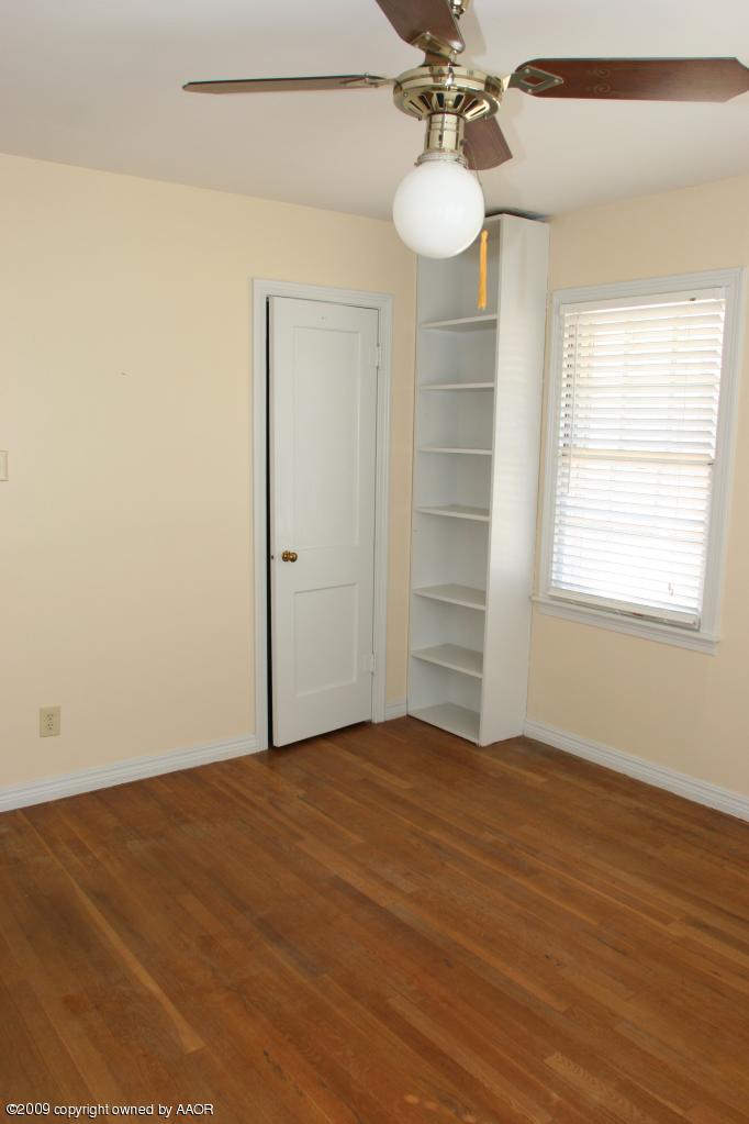 3622 South Travis Street Amarillo, TX 79110 - Photo 24 of 32 wooden floor in an empty room with a window