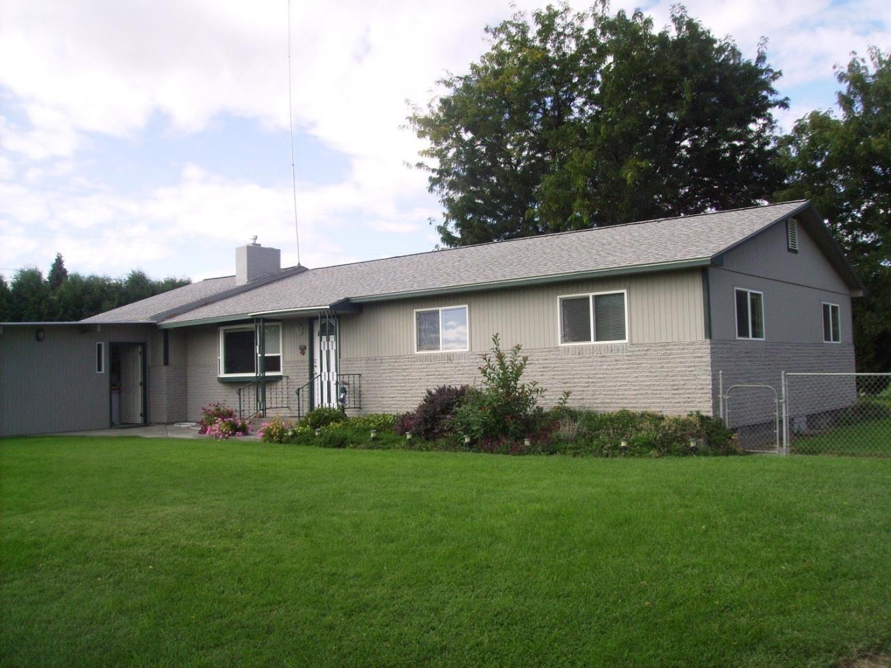 1311 Appleway Road Grandview, WA 98930 - Photo 1 of 8 a view of a house with backyard and garden