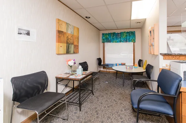 a work room with furniture and a large window