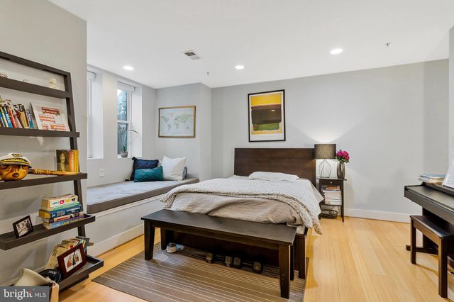 a bedroom with a bed and a bookshelf