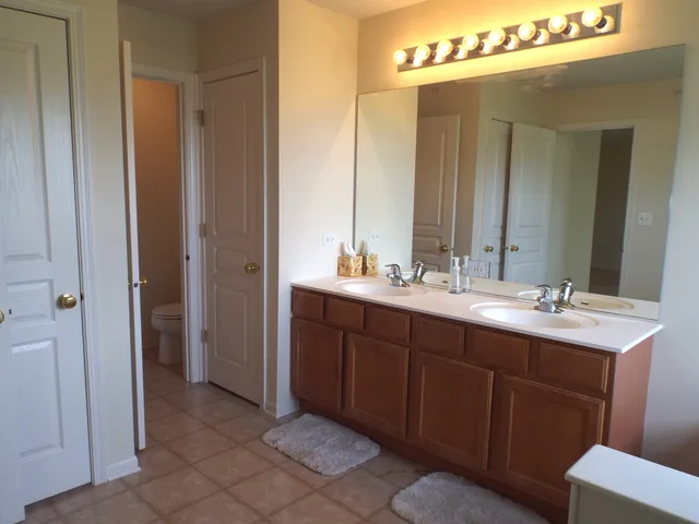 a bathroom with a double vanity sink and a mirror