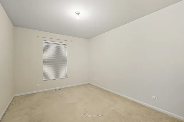 an empty room with a empty space and window