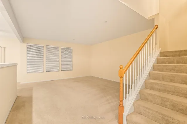 a view of an empty room with stairs