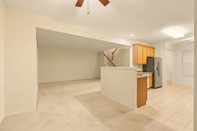 a kitchen with a refrigerator and a stove