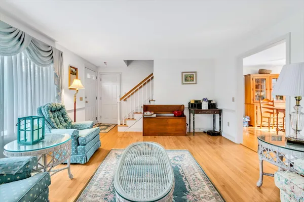 a living room with furniture a couch and two windows