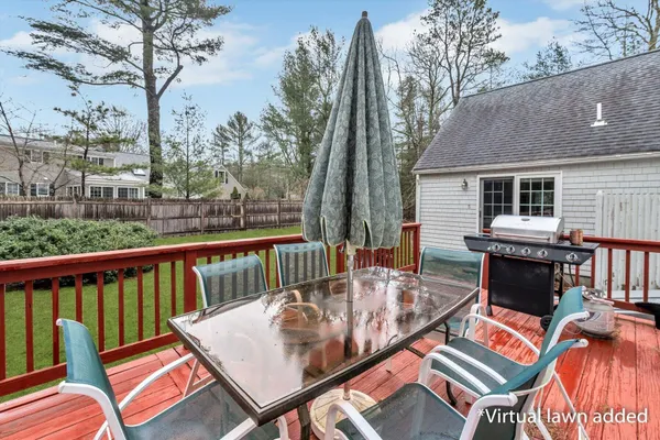 an outdoor sitting area with furniture and a yard