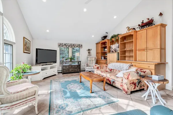 a living room with furniture fireplace and a flat screen tv