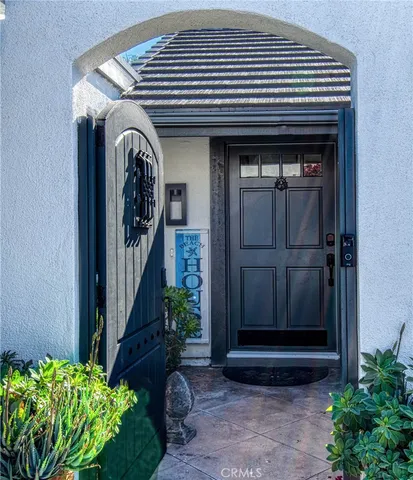 a front view of a house with entryway and plants