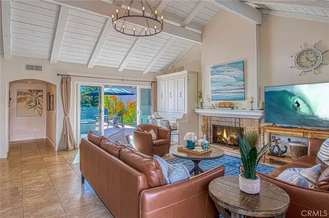 a living room with furniture potted plant and a fireplace