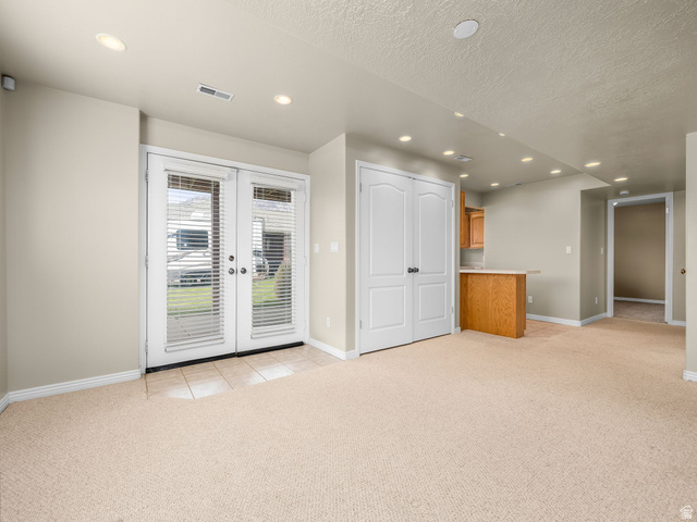 6849 North Black Powder Road Mountain Green, UT 84050 - Photo 25 of 43 Spacious room featuring neutral carpeting and recessed lighting