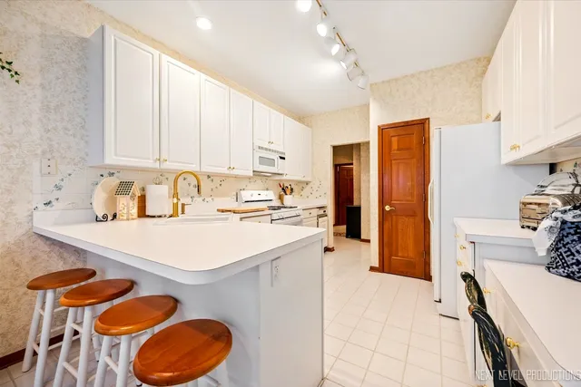 a kitchen that has a sink and a stove top oven