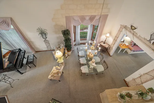 a view of a livingroom with furniture and a floor to ceiling window