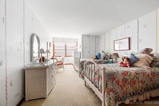 a bed room with two beds and a large window