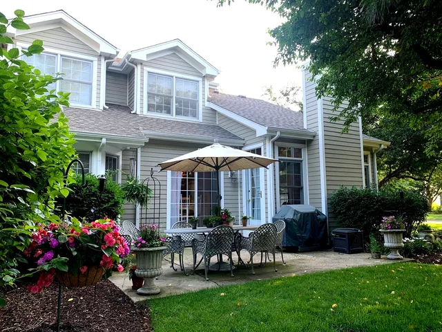 a view of a house with a yard and sitting area
