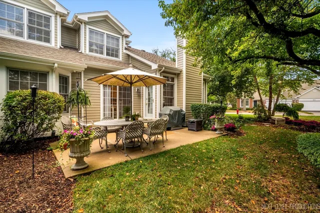 a view of a house with backyard sitting area and garden